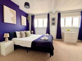 A bedroom with a bed and storage drawers at Clarence House in Llandudno