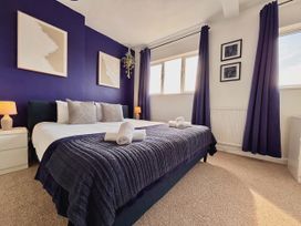 A bedroom with a bed and nightstand at Clarence House in Llandudno