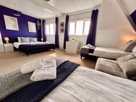 A bedroom with two beds and a window at Clarence House in Llandudno
