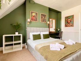 A bedroom with a bed and desk at Clarence House in Llandudno