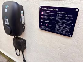 A charging station with an information sign at Clarence House in Llandudno