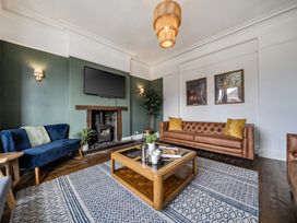 A living room with a television and coffee table at Clarence House in Llandudno