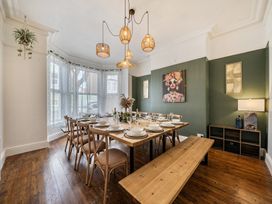 A dining room with a table set for a meal at Clarence House in Llandudno
