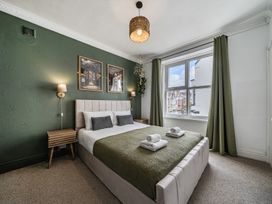 A bedroom with a double bed and nightstand at Clarence House in Llandudno