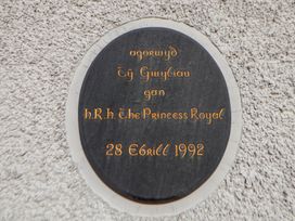 A plaque indicating opening by H.R.H. The Princess Royal at Clwyd Special Riding Centre