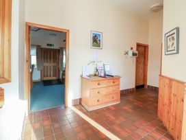 An entrance hall with a desk and doorway at Clwyd Special Riding Centre