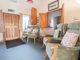 A lounge with chairs and a door at Clwyd Special Riding Centre