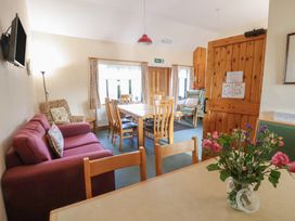 A dining room with a table and chairs at Clwyd Special Riding Centre