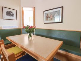 A dining room with a table and bench seating at Clwyd Special Riding Centre
