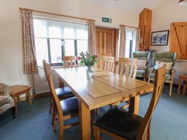 A dining room with a table and chairs at Clwyd Special Riding Centre