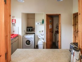 A kitchen with washing machine and sink at Clwyd Special Riding Centre