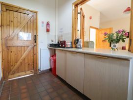 A kitchen with a countertop, kettle, toaster, and door at Clwyd Special Riding Centre 