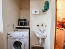 A laundry room with a washing machine and sink at Clwyd Special Riding Centre 