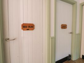 A corridor with two doors labeled Red Rum and Dusty at Clwyd Special Riding Centre