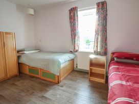 A bedroom with beds and a wardrobe at Clwyd Special Riding Centre 