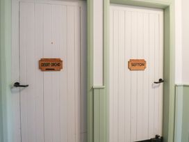 Two doors labeled Desert Orchid and Sefton in a hallway at Clwyd Special Riding Centre