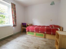 A bedroom with a bed and desk at Clwyd Special Riding Centre