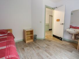 A bedroom with a bed and sink at Clwyd Special Riding Centre