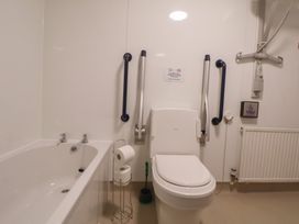 A bathroom with a bathtub and toilet at Clwyd Special Riding Centre