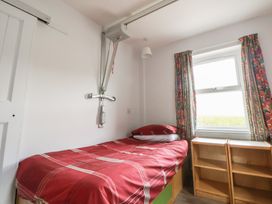 A bedroom with a bed and a window at Clwyd Special Riding Centre