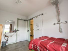 A bedroom with a bed and washbasin at Clwyd Special Riding Centre 