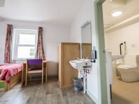 A bedroom with a bed and a desk at Clwyd Special Riding Centre