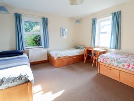 A bedroom with three beds and a desk at Clwyd Special Riding Centre in 