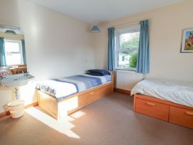 A bedroom with two beds and a sink at Clwyd Special Riding Centre