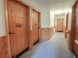 A hallway with wooden doors at Clwyd Special Riding Centre
