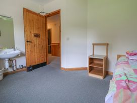 A bedroom with a bed and a nightstand at Clwyd Special Riding Centre in 