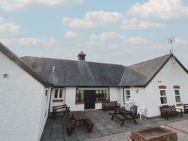 An outdoor area with benches and a building at Clwyd Special Riding Centre