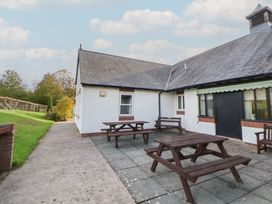 An outdoor seating area with tables at Clwyd Special Riding Centre