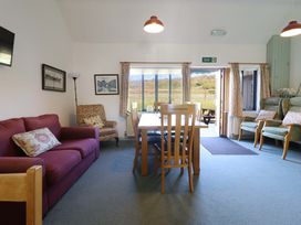 A dining room with a table and chairs at Clwyd Special Riding Centre in Llanfynydd