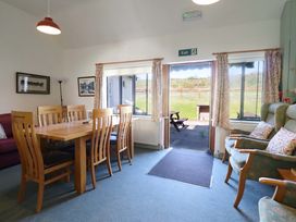 A dining room with a table and chairs at Clwyd Special Riding Centre Llanfynydd