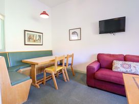 A dining area with a table and chairs at Clwyd Special Riding Centre in Llanfynydd