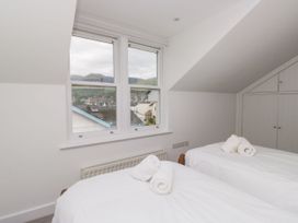 A bedroom with two beds and a view of the mountains at Swirl Howe, Keswick