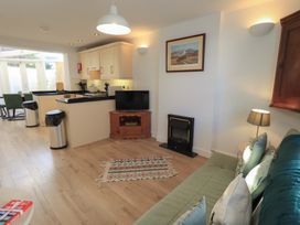 A living room with a sofa and television at Swirl Howe in Keswick