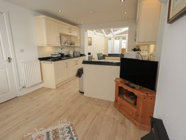 A kitchen with appliances including a sink and television at Swirl Howe in Keswick