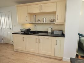 A kitchen with cabinets and a sink at Swirl Howe in Keswick