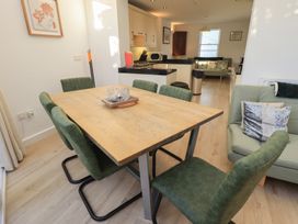A dining room with a wooden table and chairs at Swirl Howe in Keswick
