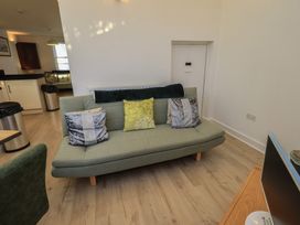 A living room with a sofa and television at Swirl Howe in Keswick