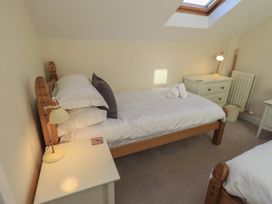 A bedroom with beds and nightstands at Swirl Howe in Keswick