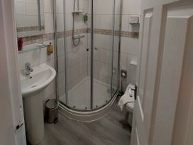 A bathroom with a sink, shower, and toilet at 1 Park Road in Windermere