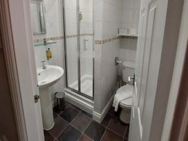 A bathroom with a shower, sink, and toilet at 1 Park Road in Windermere