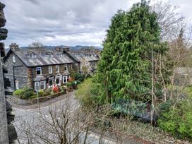 A view of houses and trees from a roof at 1 Park Road in Windermere