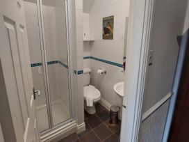 A bathroom with shower, toilet, and sink at 1 Park Road in Windermere