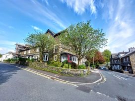 A building corner with trees and road at 1 Park Road in Windermere