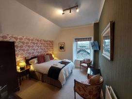 A bedroom with a bed and television at 1 Park Road Windermere