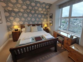 A bedroom with a bed and desk at 1 Park Road Windermere