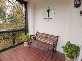 An outdoor area with a bench and plants at 1 Park Road Windermere